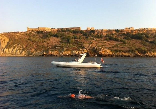 Kurt Arrigo finishes the round Gozo charity swim in 12 hours