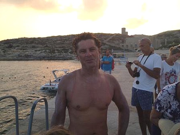 Kurt Arrigo finishes the round Gozo charity swim in 12 hours