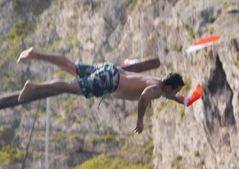 Slippery pole competition entertains the crowds in Xlendi Bay